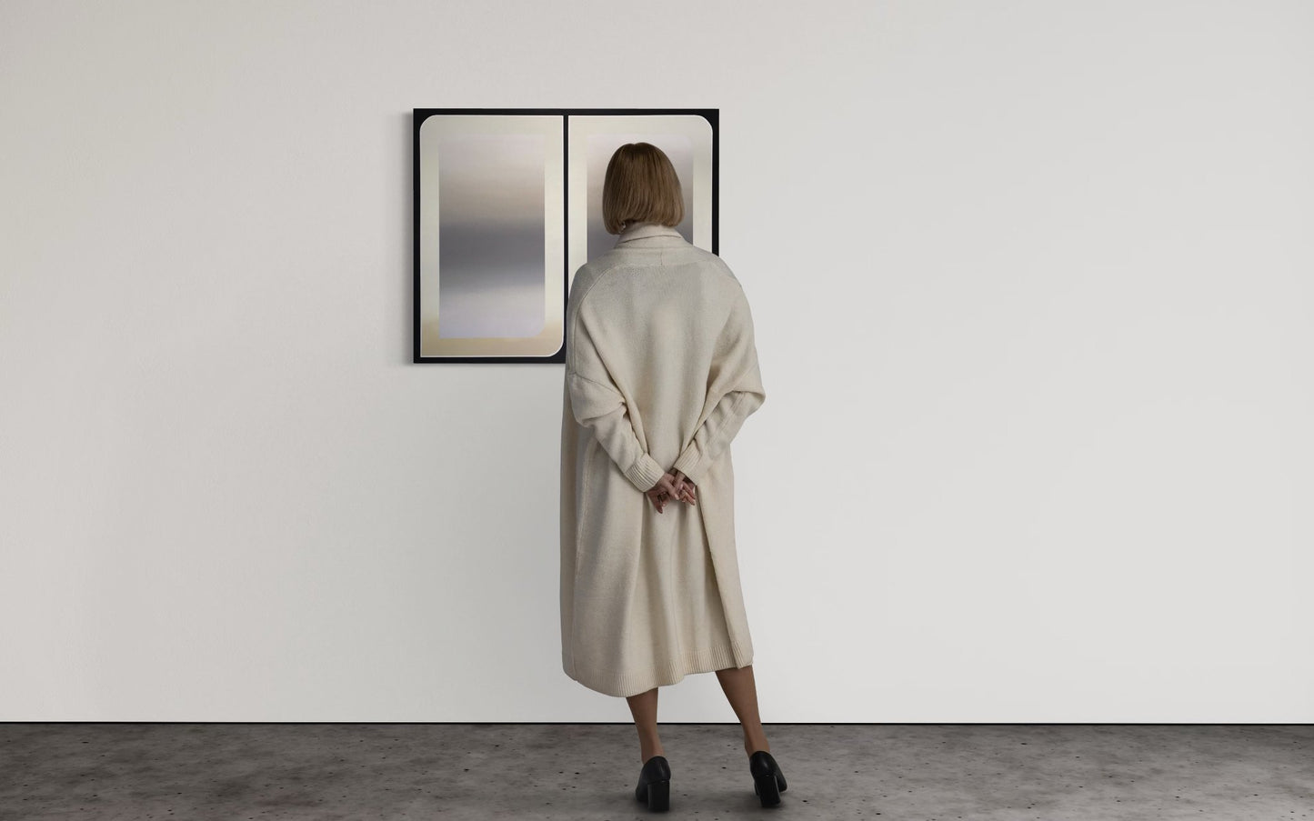 A 30x36 original atmospheric abstract painting titled The View 2 by Kevin Cross being viewed by a collector in a minimalist gallery setting on Mitsooz.