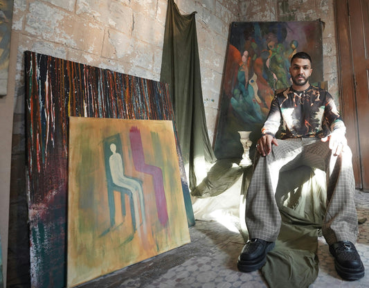 Atmospheric artist studio with sunlight and original paintings, representing the story-driven focus of the Mitsooz art collection.