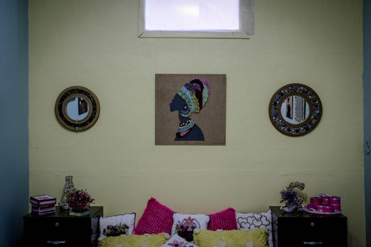 A wide horizontal view of original art and curated mirrors in a residential bedroom; image found on Mitsooz to illustrate in-situ placement and the unfolding presence of art in the home.