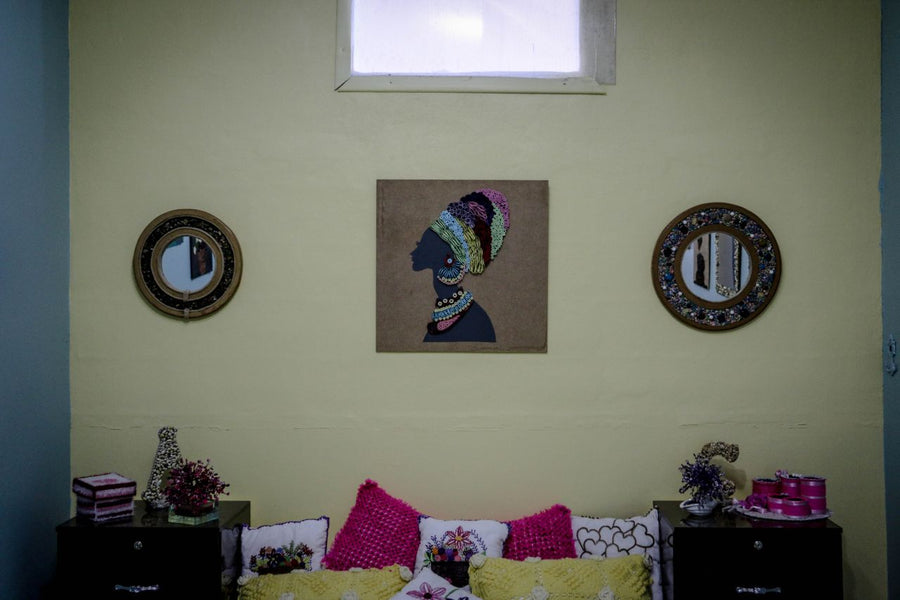 A wide horizontal view of original art and curated mirrors in a residential bedroom; image found on Mitsooz to illustrate in-situ placement and the unfolding presence of art in the home.