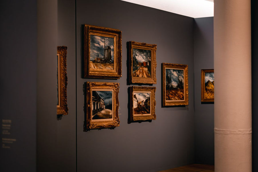 A horizontal landscape view of curated paintings in an art gallery; image found on Mitsooz to represent building visual literacy and collector confidence.