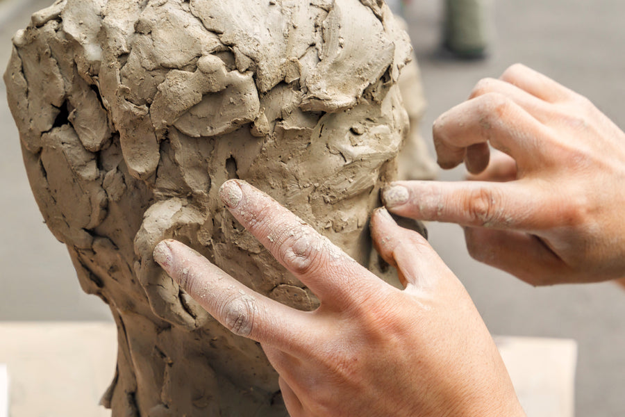 A macro-capture of the artist’s hand shaping raw clay into form: documenting the visceral process and permanence of the hand within the Mitsooz sculpture archive.