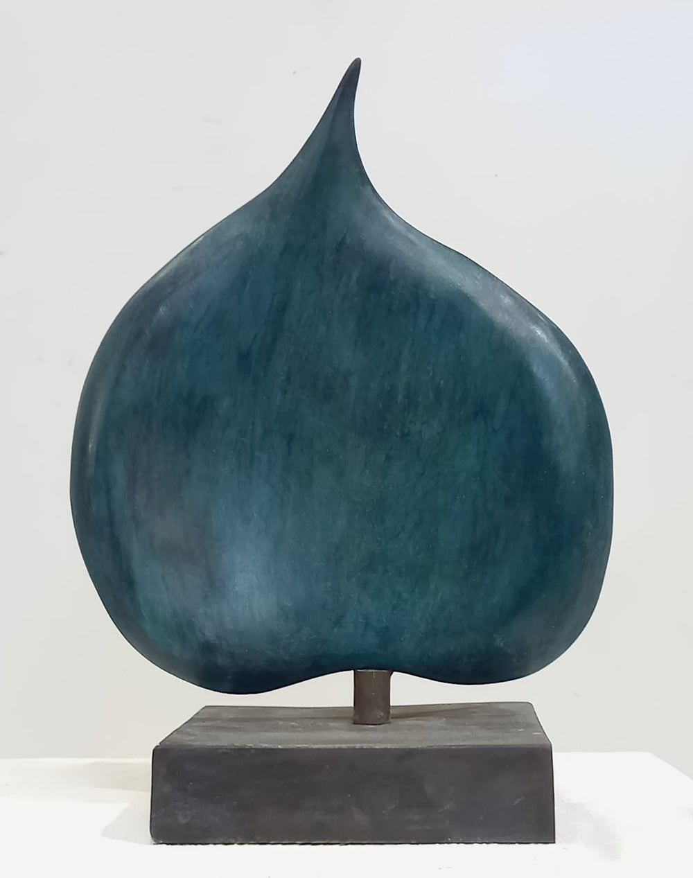 A vertical aqua blue bronze sculpture titled American Ivy Leaf by Andree Brown featuring a hand-formed spade shape with a matte cobalt patina on a solid bronze base on Mitsooz.