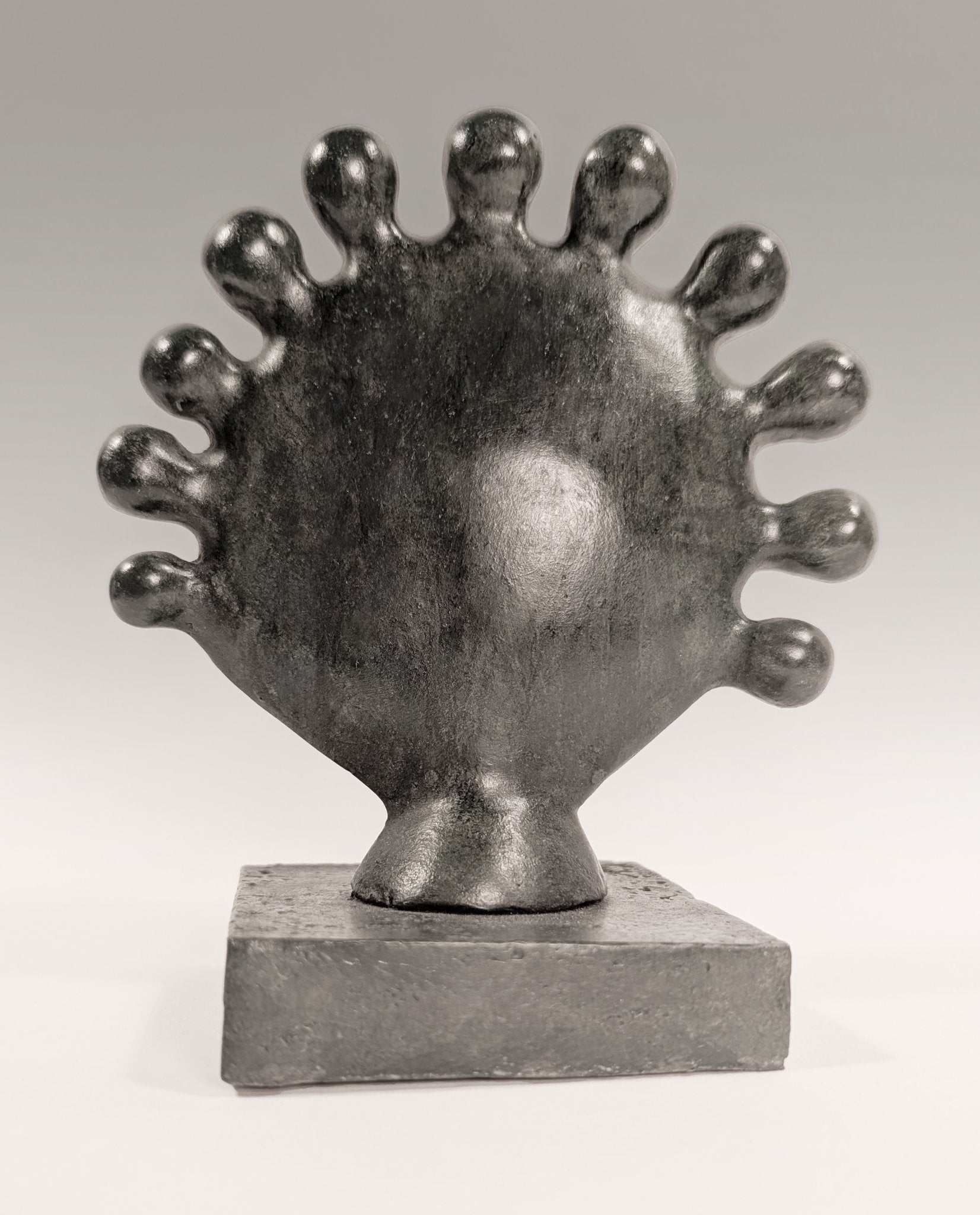 A contemporary organic bronze sculpture titled Sunflower by Andree Brown featuring a hand-formed circular floral shape with a dark gray satin-matte patina on Mitsooz.