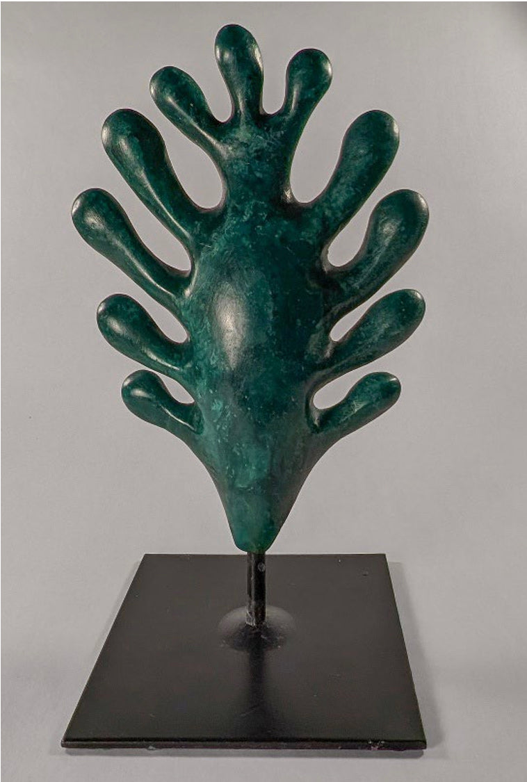 White Oak Leaf (Custom) by Andree Brown: A hand-refined mottled green porcelain sculpture on a black metal pedestal base, inspired by NYC parks. Edition 1 of 6.
