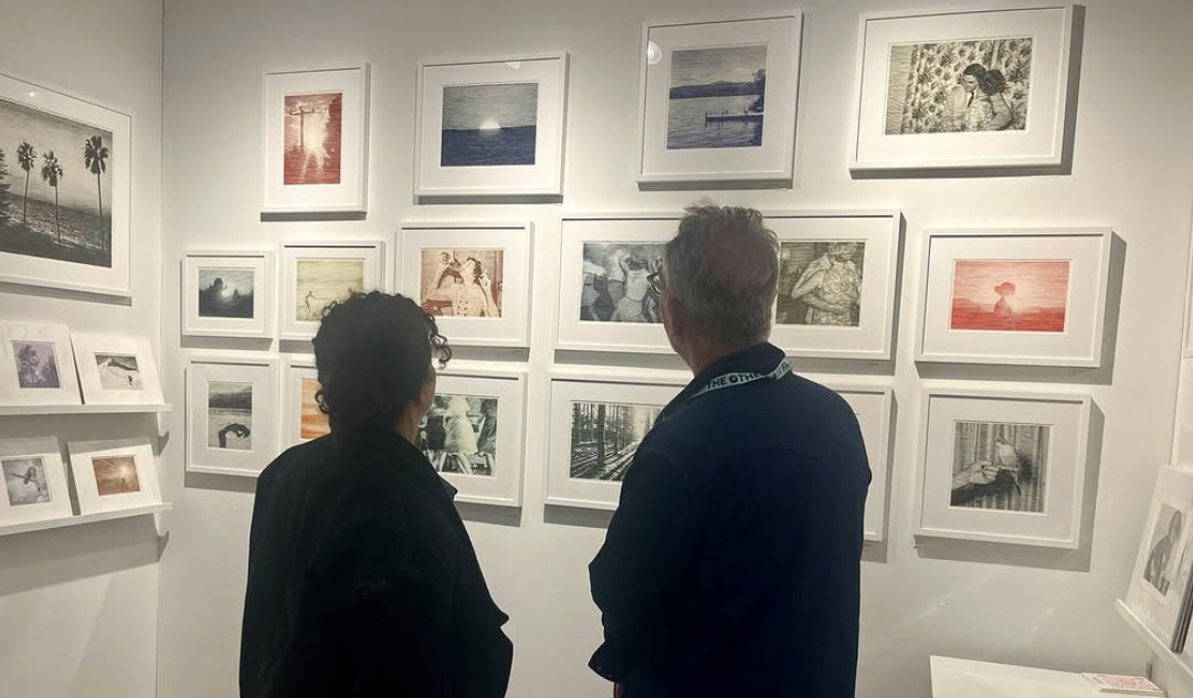 Gallery viewers admiring the framed striated ink drawings of Charles Buckley at a Susan Eley Fine Art exhibition featured on Mitsooz.