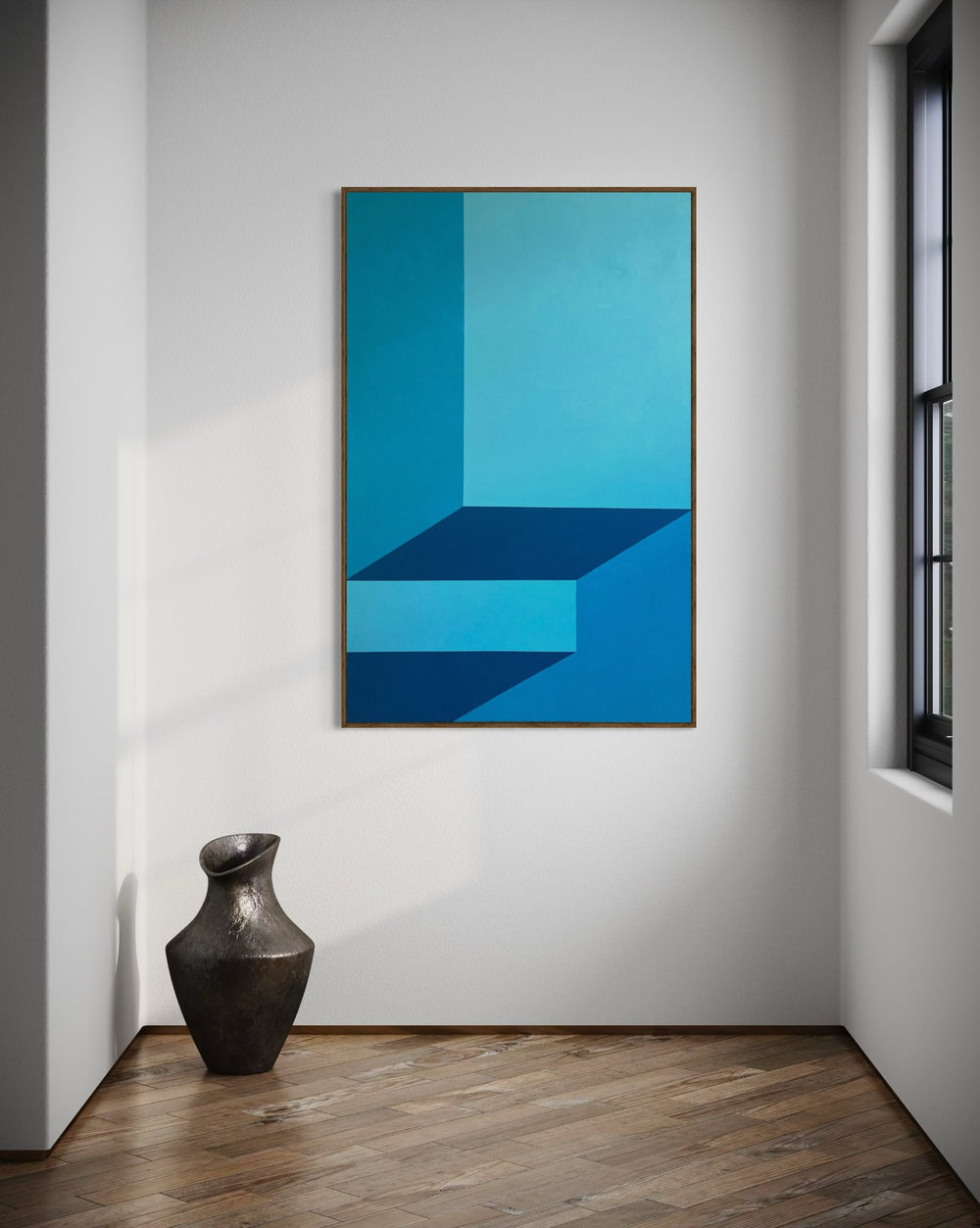 A monumental vertical original abstract painting titled Just Before the Light Gets In by Holly McWhorter, featuring geometric fields of dawn blue and cerulean. The work is displayed in a modern corner interior above a dark textured ceramic vase on a parquet wood floor at Mitsooz.