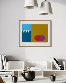 A horizontal framed original abstract painting titled Subconscious #1 by Holly McWhorter hanging on a white wall in a modern interior. The artwork features bold geometric fields of teal, blue, and ochre with a red and purple capsule shape. It is styled above a white contemporary bookshelf containing design books and a black ceramic teapot, reflecting a minimalist Copenhagen aesthetic on Mitsooz.