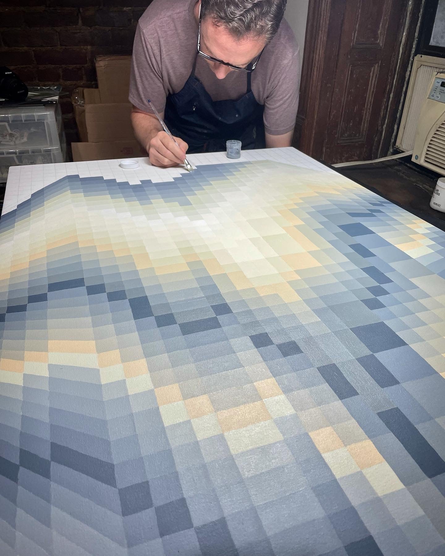 Kevin Cross at work in his New York City studio. Illustrating the scale and the rhythmic, repetitive process used to build his large-format atmospheric paintings.