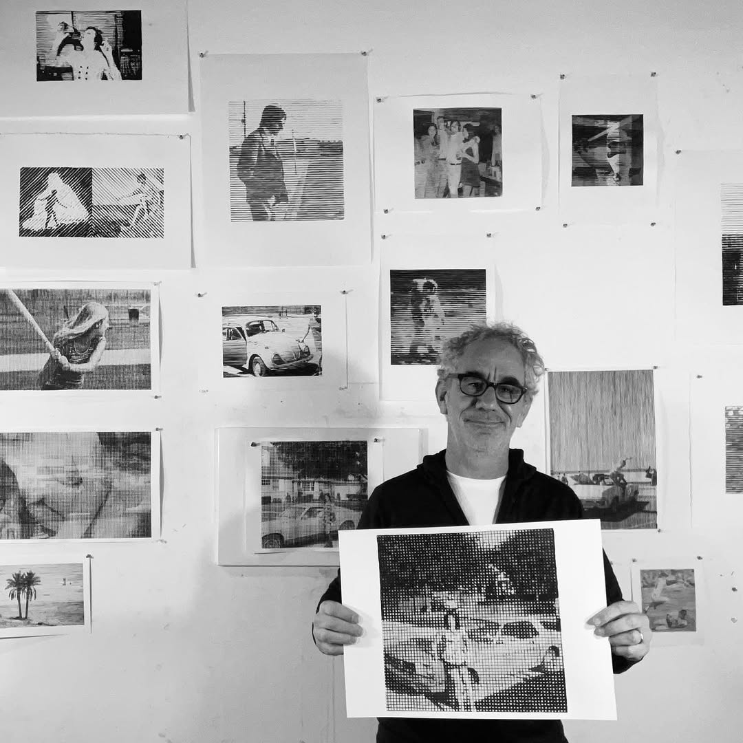 Artist Charles Buckley holding a completed striated ink drawing in his Brooklyn studio for his Mitsooz profile.
