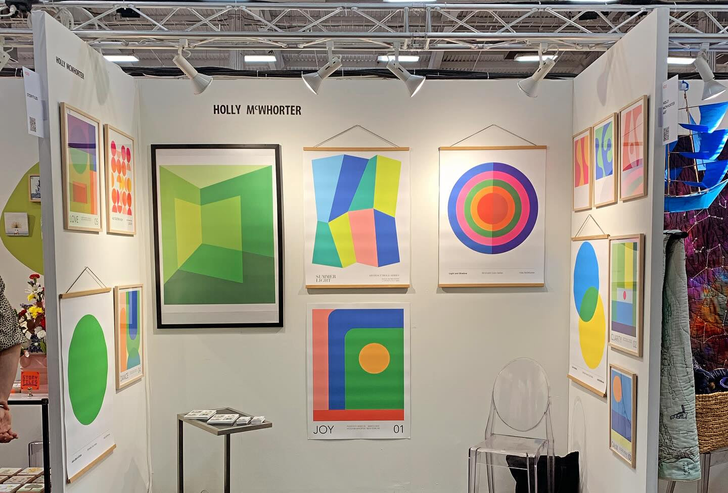 An exhibition booth at the Shoppe Object trade show featuring interdisciplinary abstract art by mitsooz artist Holly McWhorter. The display highlights her prints, including "Joy 01" and "Summer Light," reflecting her design-led focus on structural balance, architectural clarity, and the emotional resonance of color.