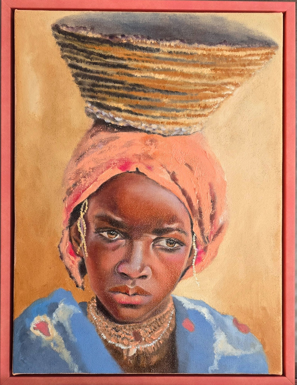 A vertical 9x12 original oil painting titled Resolve by Nersel Muehlen featuring a young African girl with a steady gaze and a woven basket balanced on her head. The portrait showcases warm earthy tones, a coral headwrap, and a blue garment, rendered with photorealistic precision and expressive textures on Mitsooz.
