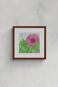 Square original botanical watercolor titled Fuchsia Gerbera Daisy by Ruth Wall featuring a deep pink bloom and green leaves in a mahogany frame on Mitsooz.