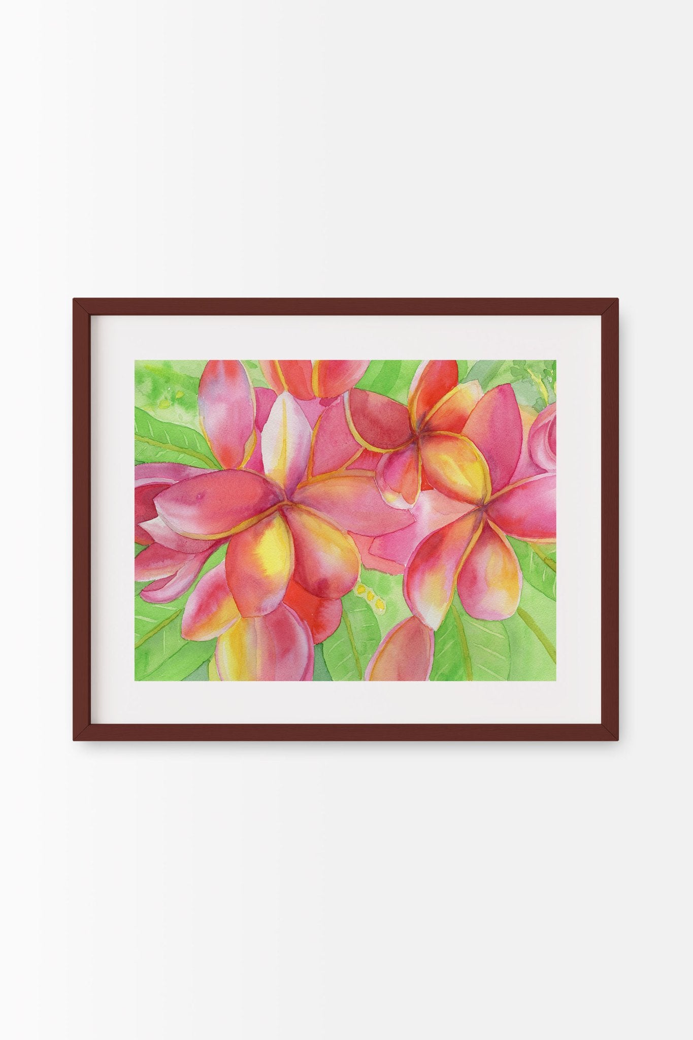 A horizontal 18x14 original botanical watercolor painting titled The Sunset Plumeria by Ruth Wall, featuring wonderfully vibrant deep pink and yellow blooms among lemony green leaves in a dark mahogany frame on Mitsooz.