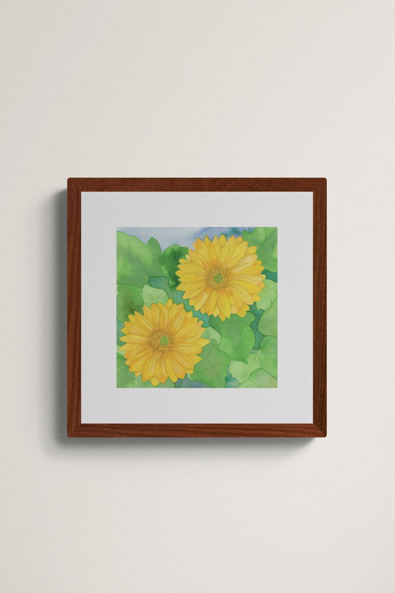 Square original watercolor painting titled Two Yellow Gerbera Daisies by Ruth Wall featuring two golden blooms and lush green leaves in a mahogany frame on Mitsooz.